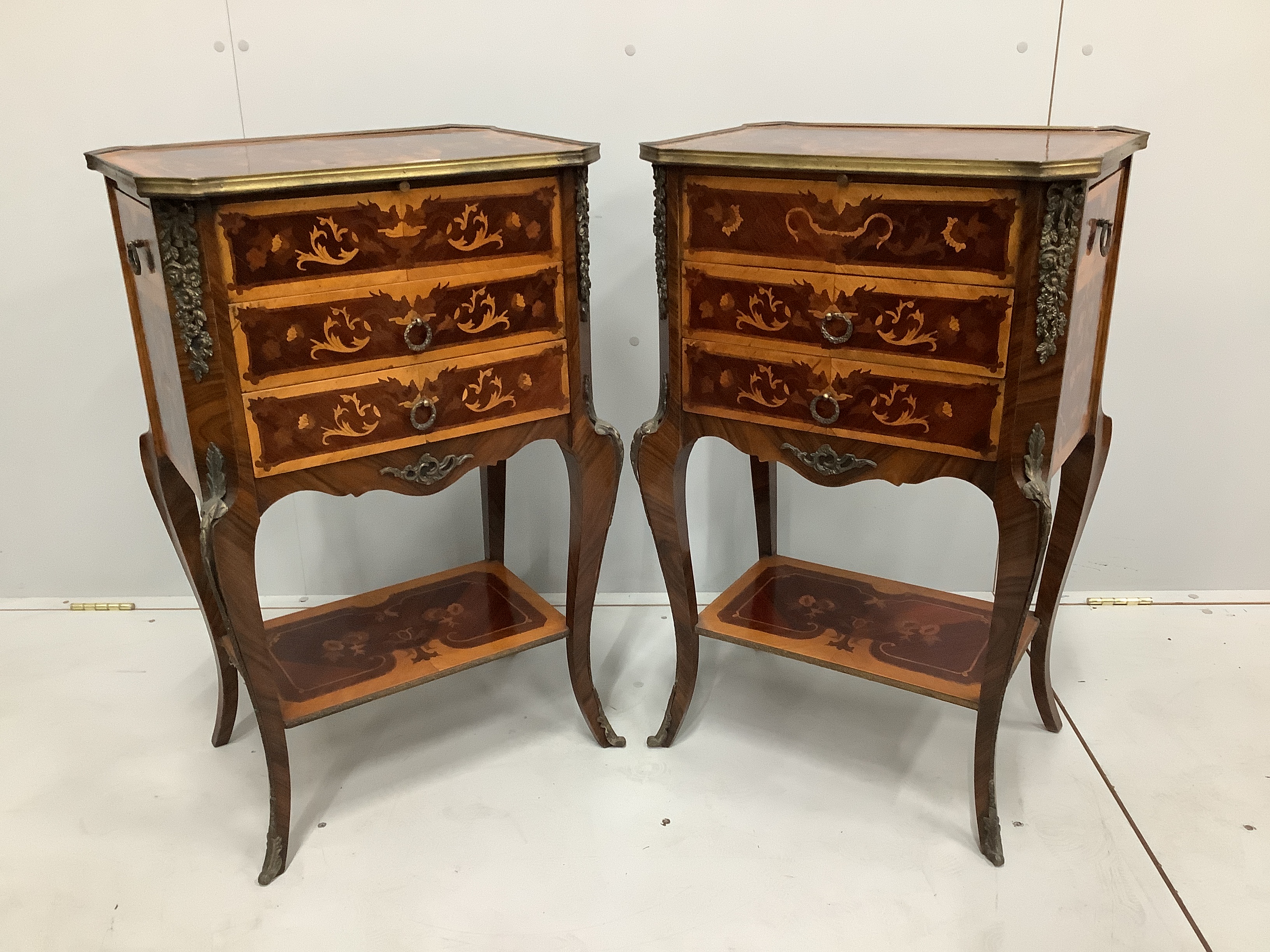 A pair of Louis XVI style marquetry inlaid gilt metal mounted kingwood three drawer bedside tables, width 51cm, depth 37cm, height 81cm